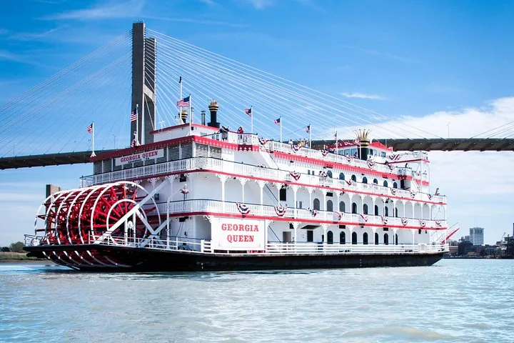 Georgia Queen riverboat sailing under the Talmadge Memorial Bridge on a sunny day.
